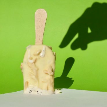 Shadow of a hand reaching an icecream